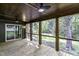 Covered wooden patio with ceiling fans and a view of a wooded area at 434 Robin Rd, Chapel Hill, NC 27516