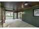 Covered wooden patio featuring ceiling fans and green siding with a view of the yard at 434 Robin Rd, Chapel Hill, NC 27516