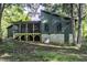 Exterior view of home with an elevated, screened-in porch and a partial basement at 434 Robin Rd, Chapel Hill, NC 27516