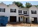 New construction townhome with white siding, black shutters, and an attached two-car garage at 45 Calluna Dr, Clayton, NC 27520