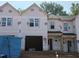 New construction townhome featuring garage, front door and multiple windows ready for finishing touches at 45 Calluna Dr, Clayton, NC 27520