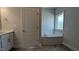Well-lit bathroom featuring a soaking tub, vanity with countertop, and stylish tile flooring at 457 Sweet Potato Lane # 13, Nashville, NC 27856