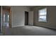 Comfortable bedroom with soft carpeting, natural light, and a closet, offering a tranquil retreat at 457 Sweet Potato Lane # 13, Nashville, NC 27856