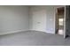 Bright bedroom with a double closet, carpet floors, and an entrance to another room at 457 Sweet Potato Lane # 13, Nashville, NC 27856