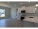 Modern kitchen featuring white cabinets, stainless steel appliances, and open view to the adjacent breakfast area at 457 Sweet Potato Lane # 13, Nashville, NC 27856