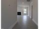 Bright living room featuring a fireplace, neutral paint, and modern vinyl flooring throughout the open space at 457 Sweet Potato Lane # 13, Nashville, NC 27856