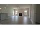 Bright living room features vinyl floors, a fireplace, and a ceiling fan; adjacent to the kitchen area at 457 Sweet Potato Lane # 13, Nashville, NC 27856