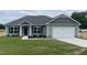 Charming one-story home featuring a two-car garage, well-manicured lawn and stone accents at 473 Sweet Potato Lane # 12, Nashville, NC 27856