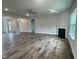 Spacious living room featuring hardwood floors, a fireplace, ceiling fan and lots of natural light at 473 Sweet Potato Lane # 12, Nashville, NC 27856