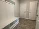 Mudroom featuring built-in bench with storage and easy access to garage and other living areas at 473 Sweet Potato Lane # 12, Nashville, NC 27856