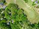An aerial view of a golf course with lush green fairways and greens surrounded by trees at 4969 Royal Adelaide Way, Raleigh, NC 27604