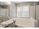 Bathroom with a mosaic tile countertop and a soaking tub at 4969 Royal Adelaide Way, Raleigh, NC 27604