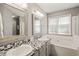 Updated bathroom with double sinks, tiled countertops, and a soaking tub at 4969 Royal Adelaide Way, Raleigh, NC 27604