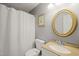 Full bathroom with white shower curtain, tan countertop, and gold framed mirror at 4969 Royal Adelaide Way, Raleigh, NC 27604