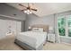 Bedroom with gray walls, a ceiling fan and an upholstered headboard on the bed at 4969 Royal Adelaide Way, Raleigh, NC 27604