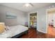 Bedroom with hardwood floors, ceiling fan, closet with shelving, and window view at 4969 Royal Adelaide Way, Raleigh, NC 27604
