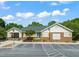 Exterior shot of the clubhouse, featuring ample parking and well-maintained landscaping at 4969 Royal Adelaide Way, Raleigh, NC 27604