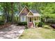 Charming home featuring a brick pathway leading to the front door and surrounded by mature trees at 4969 Royal Adelaide Way, Raleigh, NC 27604