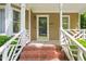 Inviting front porch featuring brick steps and white railings providing curb appeal at 4969 Royal Adelaide Way, Raleigh, NC 27604