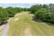 View of a meticulously maintained fairway and green, showcasing the community's golf course at 4969 Royal Adelaide Way, Raleigh, NC 27604