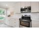 Kitchen with white cabinets, subway tile backsplash, stainless appliances, and quartz countertops at 4969 Royal Adelaide Way, Raleigh, NC 27604