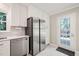 Kitchen with stainless appliances, white cabinets, and a door to the outside patio at 4969 Royal Adelaide Way, Raleigh, NC 27604