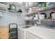 Well-organized laundry room with washer, dryer, shelving, and cleaning supplies at 4969 Royal Adelaide Way, Raleigh, NC 27604