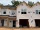 New construction townhome showing the frame, windows, and garage, ready for finishing touches at 51 Calluna Dr, Clayton, NC 27520