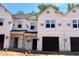 New construction townhomes featuring covered entryways, attached garages, and durable, weather-resistant exterior finishes at 51 Calluna Dr, Clayton, NC 27520