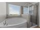 Bathroom showcases a luxurious soaking tub next to a glass-enclosed shower, promising relaxation and convenience at 520 Austin View Blvd, Wake Forest, NC 27587