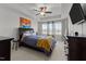 Bedroom with tray ceiling, ceiling fan, a large bed, and an entertainment center with mounted TV at 520 Austin View Blvd, Wake Forest, NC 27587
