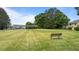 Open green common area with bench seating and shelter in the distance surrounded by many homes at 520 Austin View Blvd, Wake Forest, NC 27587