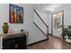 Inviting entryway with wood floors, staircase, and a brightly lit front door at 520 Austin View Blvd, Wake Forest, NC 27587