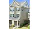 Charming townhome exterior featuring mixed brick and siding, complemented by neat landscaping at 520 Austin View Blvd, Wake Forest, NC 27587