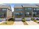 View of townhome with backyard decks, attached garages and well manicured front yard at 520 Austin View Blvd, Wake Forest, NC 27587