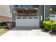 Attached garage with driveway and green exterior; convenient for parking at 520 Austin View Blvd, Wake Forest, NC 27587