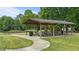 Covered outdoor picnic area with trash receptacle and several picnic tables with a walkway at 520 Austin View Blvd, Wake Forest, NC 27587