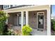 Charming brick porch featuring decorative hanging plants and a welcoming entrance at 520 Austin View Blvd, Wake Forest, NC 27587