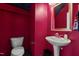Striking powder room featuring vibrant fuchsia walls, modern fixtures and contemporary dark blue floral wallpaper at 520 Austin View Blvd, Wake Forest, NC 27587