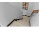 Carpeted staircase with wooden railing ascends next to a neutral-toned wall, creating a welcoming transition between floors at 520 Austin View Blvd, Wake Forest, NC 27587