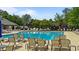 Community swimming pool with lounge chairs and mature trees at 520 Austin View Blvd, Wake Forest, NC 27587