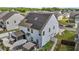 Aerial view of house with solar panels, backyard with patio, and privacy fence at 528 Brycewood Dr, Burlington, NC 27215