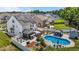 Aerial shot of backyard, showcasing the pool, patio, solar panels, and privacy fence at 528 Brycewood Dr, Burlington, NC 27215