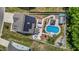 Aerial view of backyard with pool, outdoor seating, and solar panels on the roof at 528 Brycewood Dr, Burlington, NC 27215