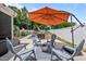 Backyard featuring patio seating beneath a large orange umbrella, great for entertaining guests outdoors at 528 Brycewood Dr, Burlington, NC 27215