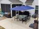 Backyard patio featuring a glass-topped table with chairs and an umbrella at 528 Brycewood Dr, Burlington, NC 27215