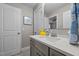 This bathroom features a gray vanity with white quartz countertop, stainless steel faucet, and tiled flooring at 528 Brycewood Dr, Burlington, NC 27215