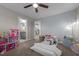 This charming bedroom features neutral walls, plush carpet, and a darling day bed with a basket and dollhouse at 528 Brycewood Dr, Burlington, NC 27215