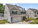 A beautiful two-story home with stone accents, and a cozy front porch with outdoor seating at 528 Brycewood Dr, Burlington, NC 27215