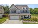 Beautiful two-story home featuring stone accents, a two-car garage, and a charming covered front porch at 528 Brycewood Dr, Burlington, NC 27215